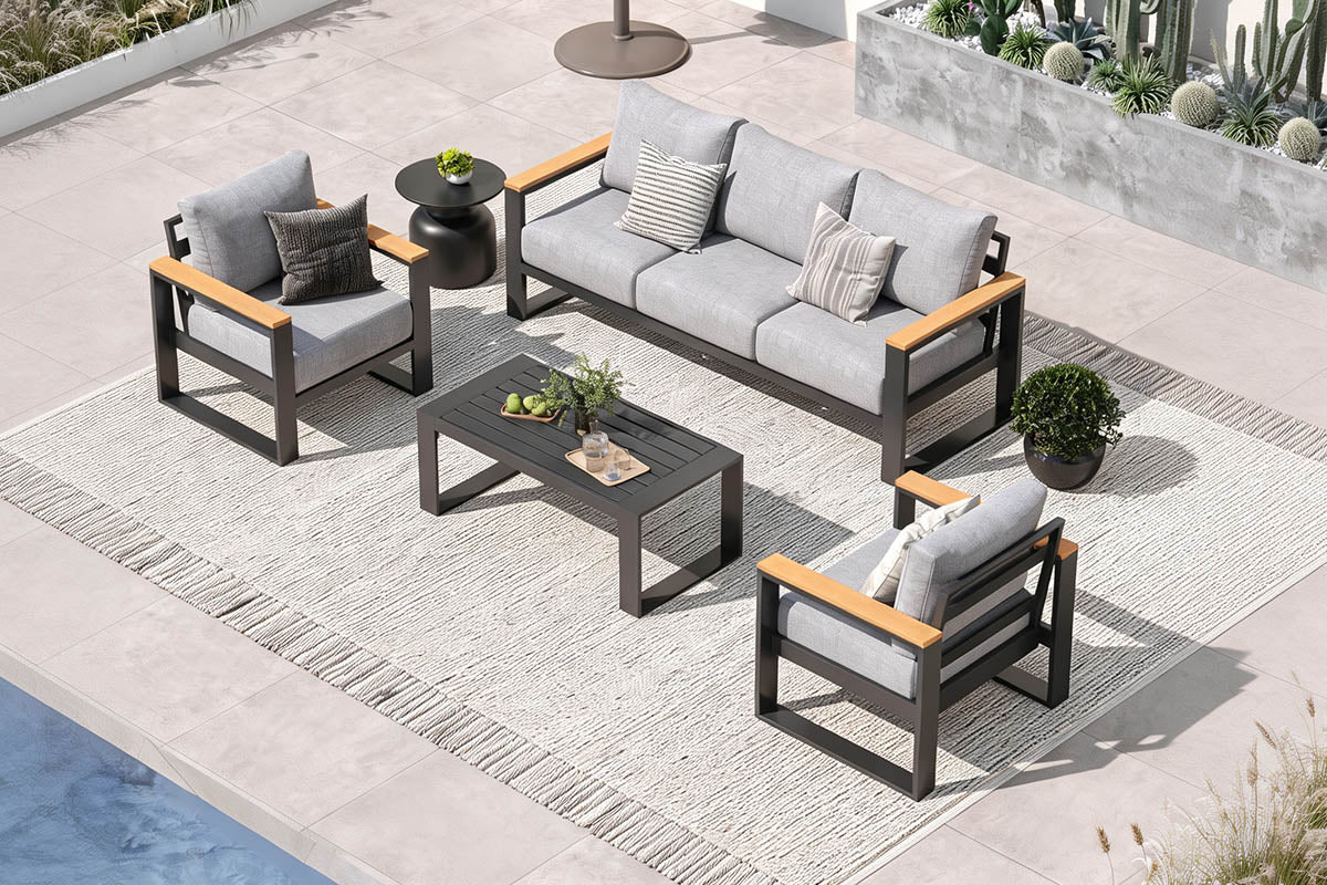Outdoor patio furniture set with gray cushions and wooden accents on a patio.
