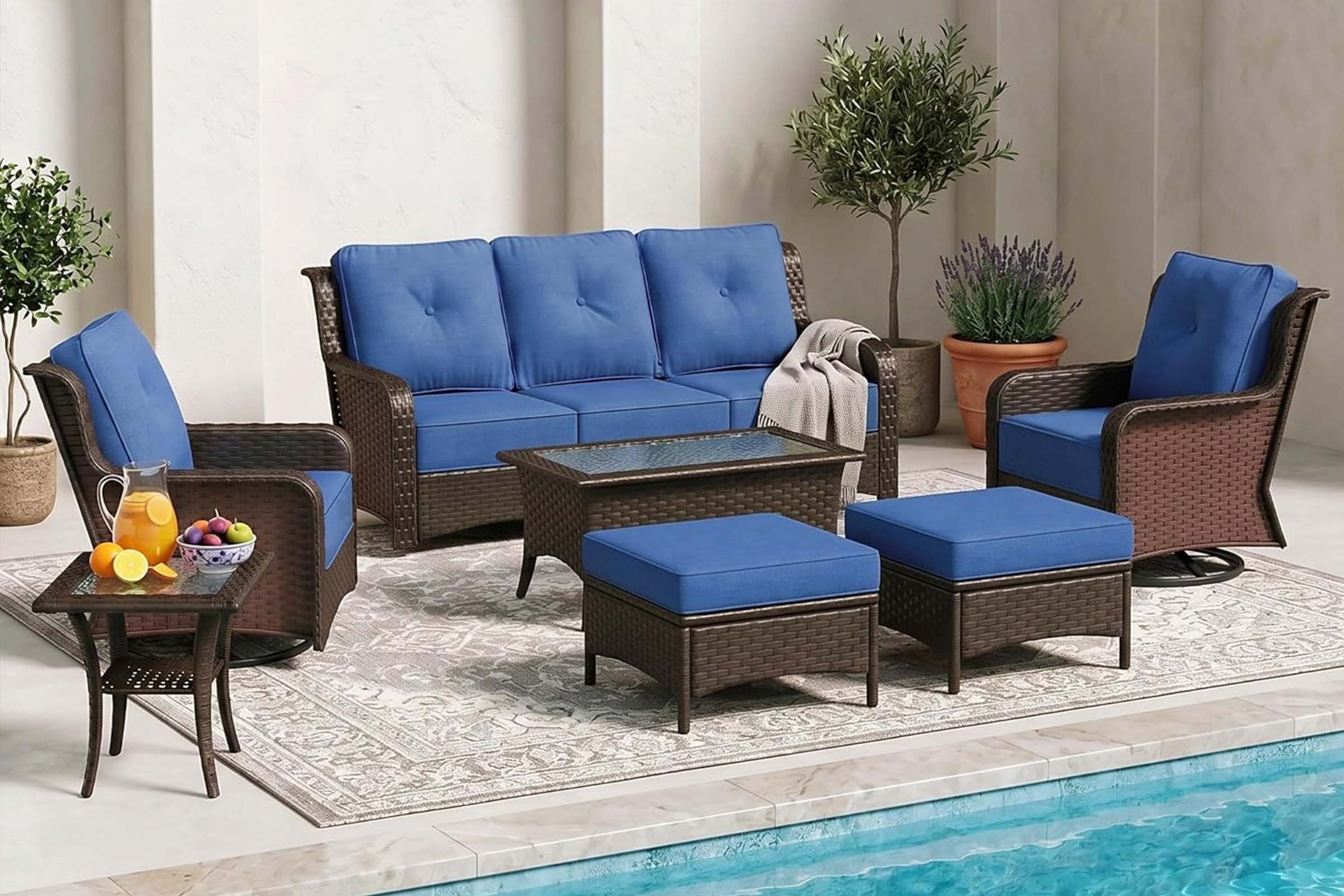 Outdoor patio furniture set with blue cushions by a pool.#color_navy