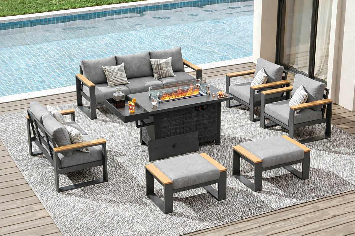 Outdoor patio furniture set with fire pit table by a pool.#color_light gray