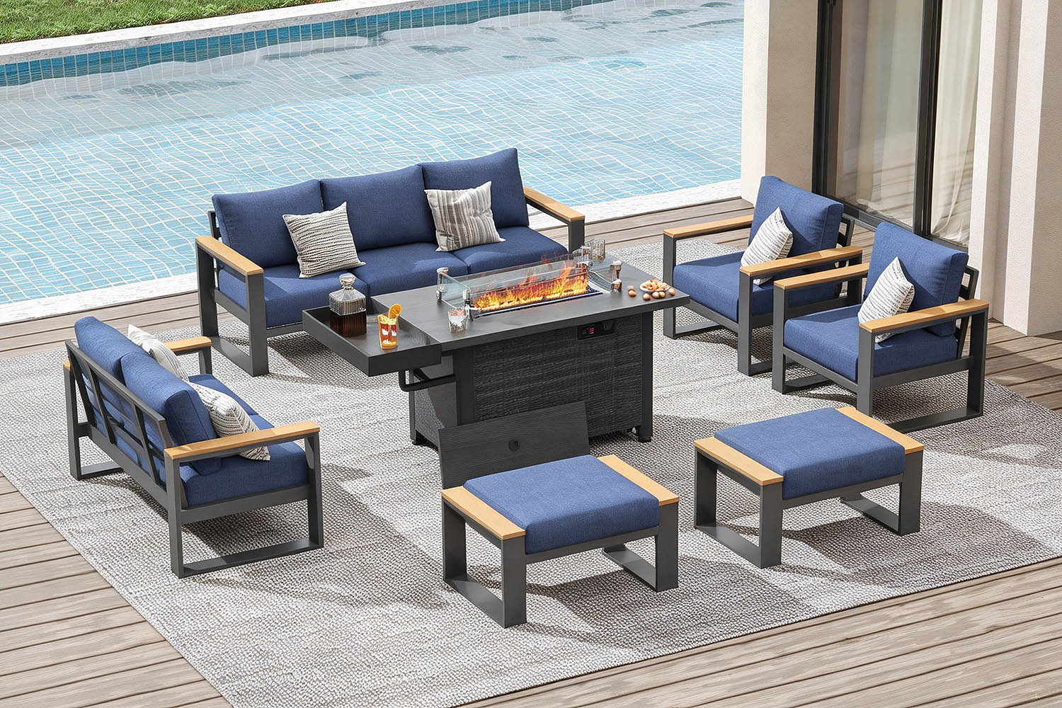 Outdoor patio furniture set with blue cushions by a pool.#color_deep navy