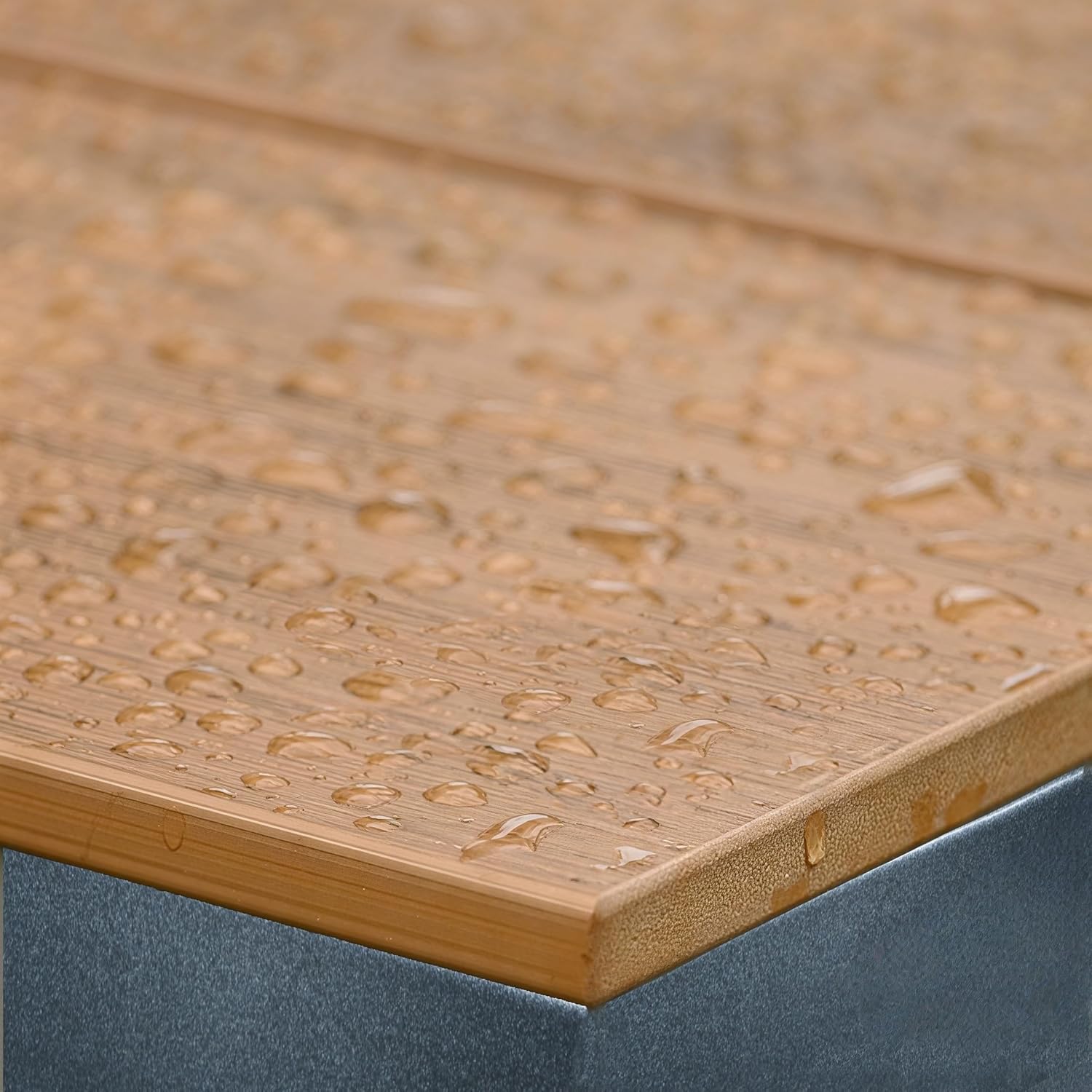 Close-up of a wooden surface with water droplets on it