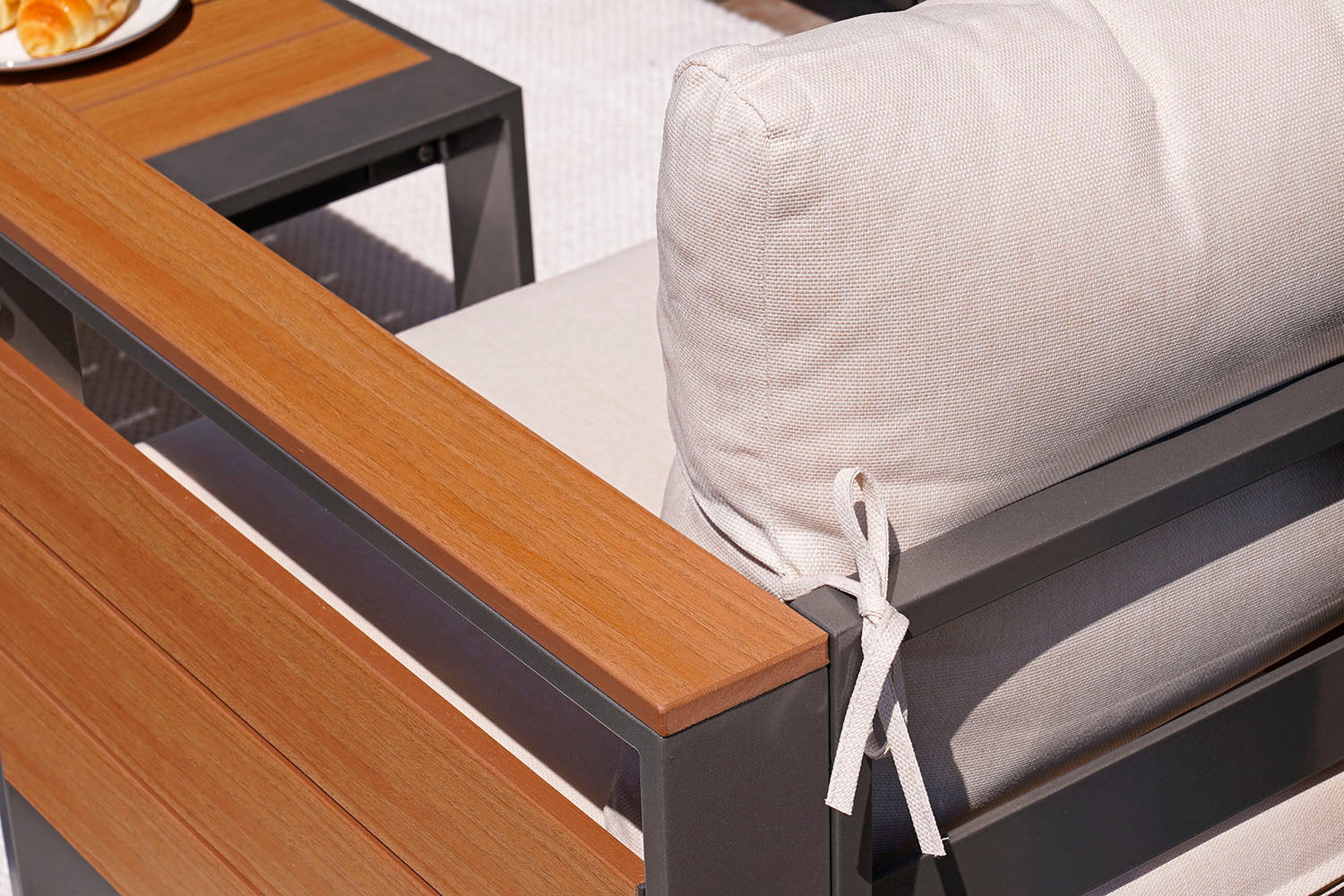 Outdoor furniture set with wooden finish bench and cushioned chair.#color_beige