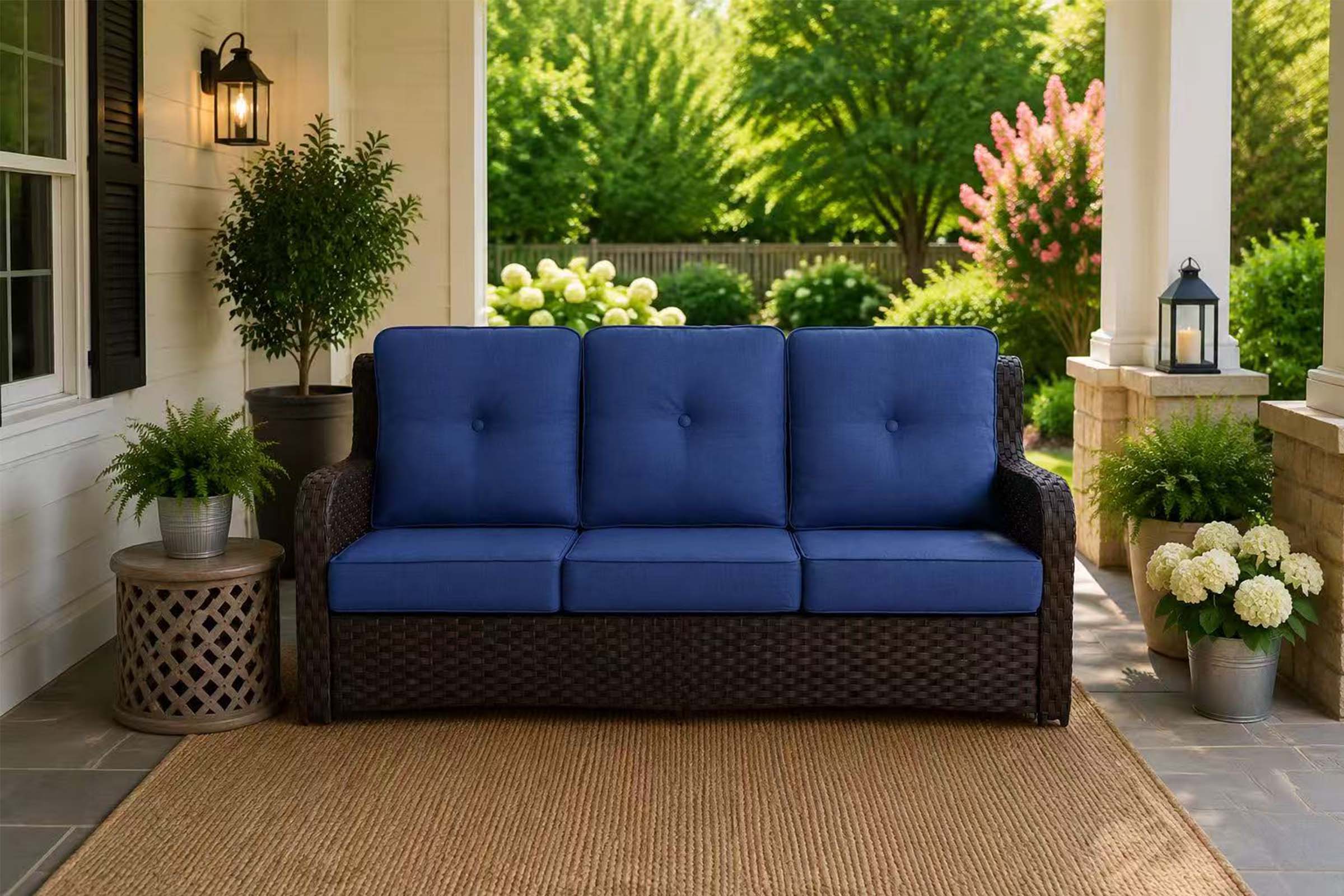 3-Seat_Patio_Wicker_Sofa with navy cushions on the patio.#color_navy