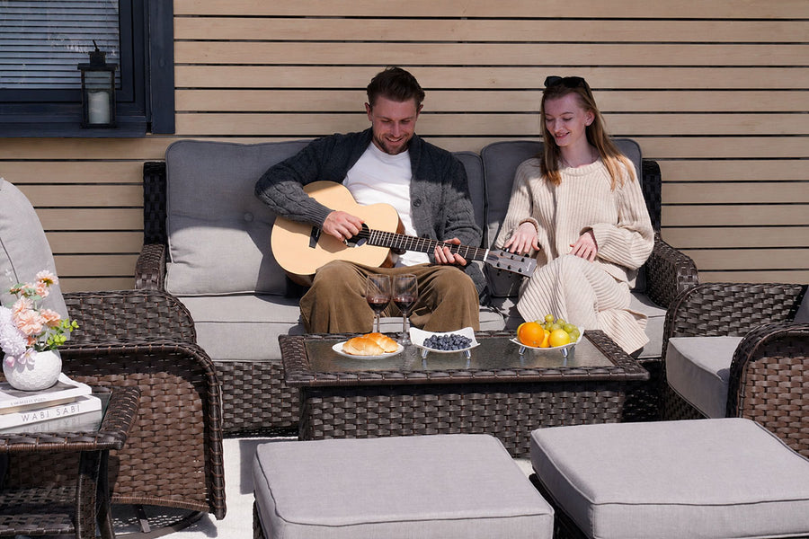a couple seating on the 3-Seat_Patio_Wicker_Sofa