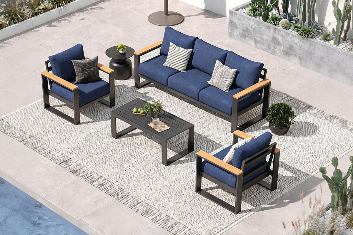 Outdoor patio furniture set with blue cushions on a patio area.
