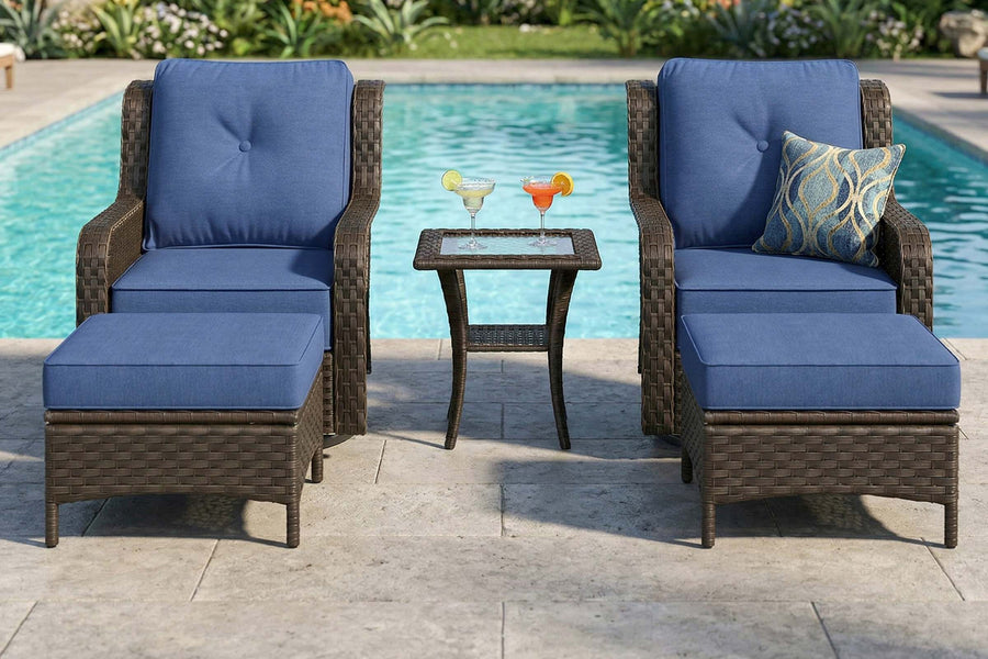 Outdoor furniture set with blue cushions by a pool