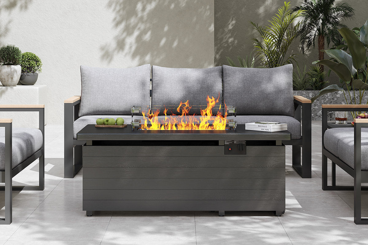 Outdoor patio setting with a fire pit table and gray sofa.#color_gray