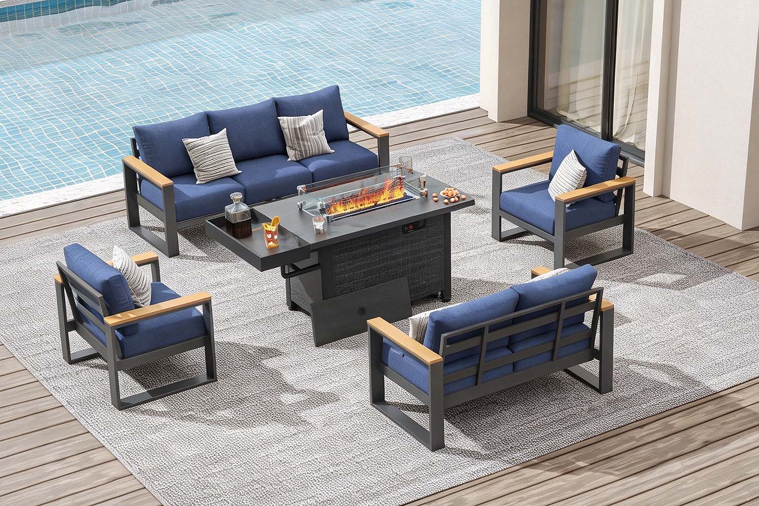 Outdoor patio furniture set with blue cushions by a pool.#color_deep navy