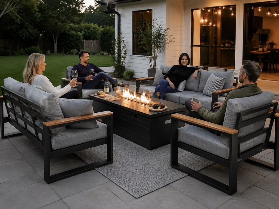 People sitting around a fire pit table in an outdoor setting