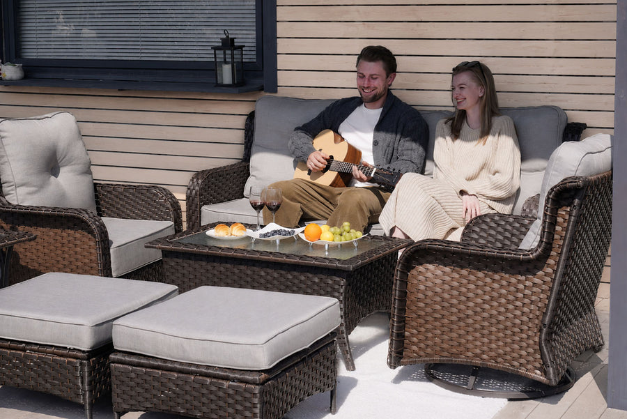 A couple sitting in the 6-Piece_Outdoor_Wicker_Swivel_Chairs_Conversation_Set