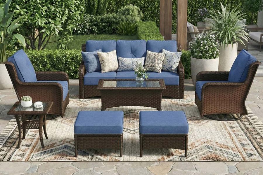 Outdoor patio set with blue cushions on a stone patio