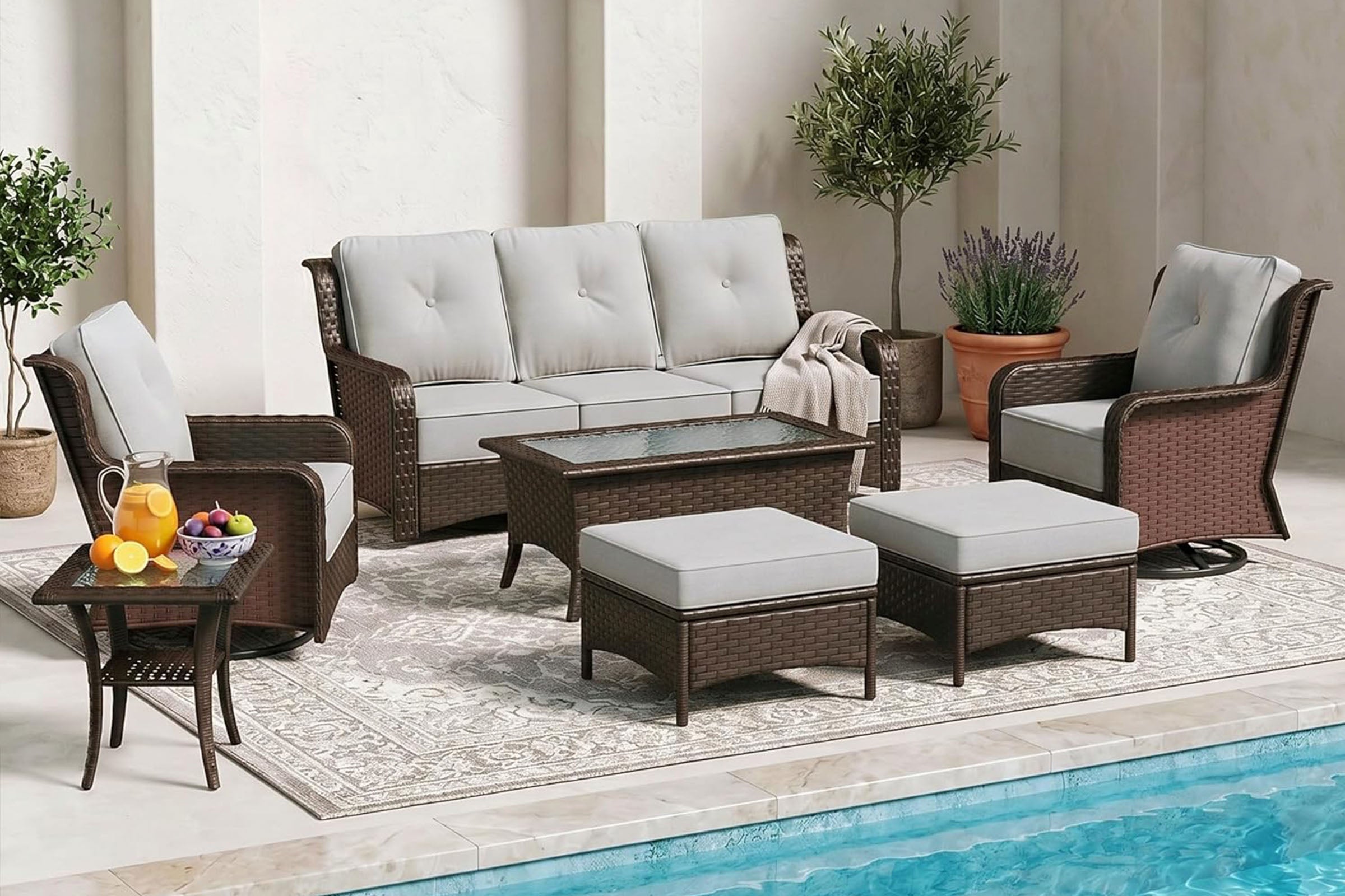 Outdoor patio furniture set with sofa, chairs, and table by a pool.#color_gray