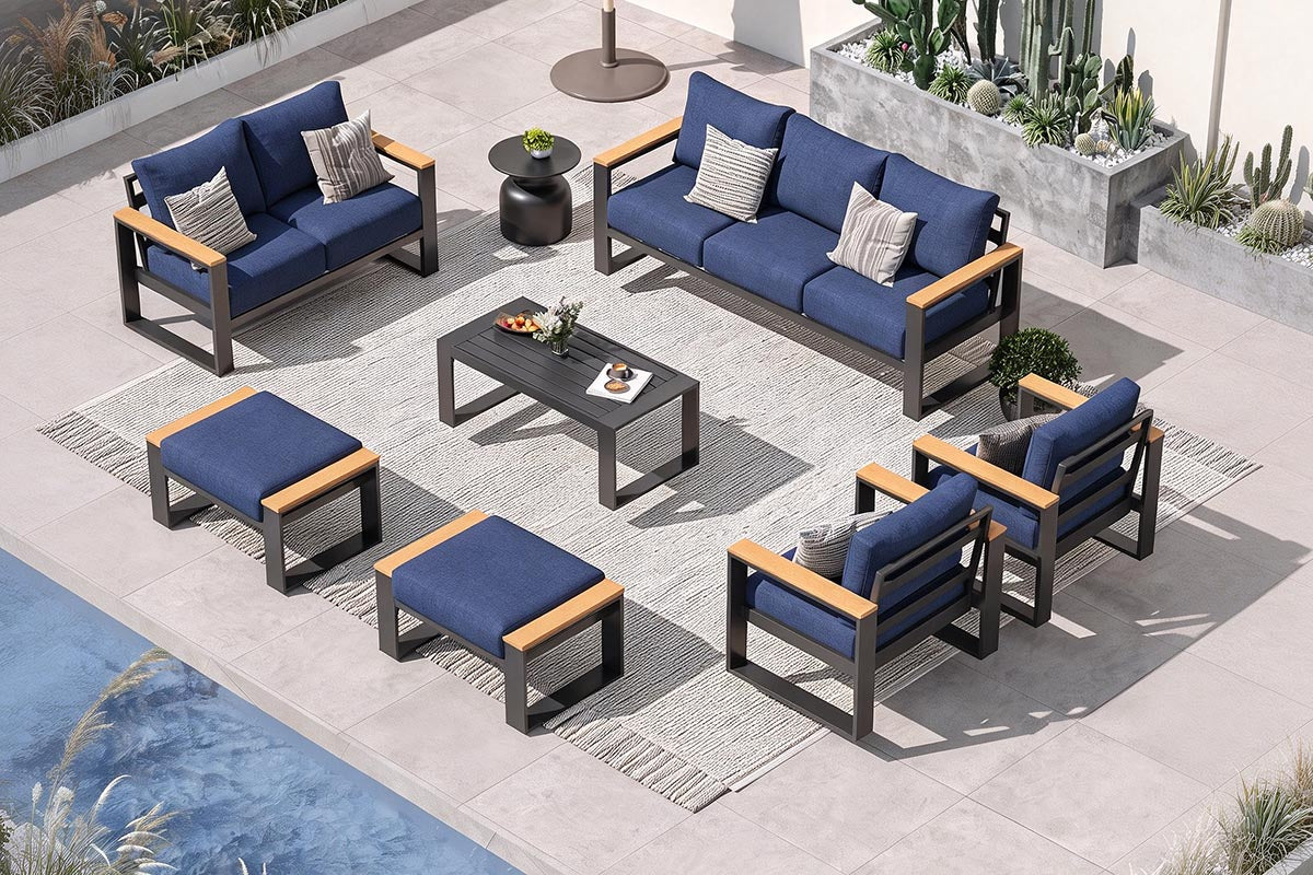 Outdoor patio furniture set with blue cushions and wooden accents on a patio.#color_deep navy