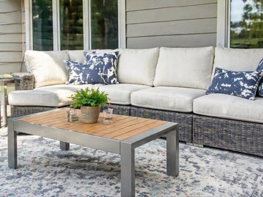 Outdoor patio set with sectional sofa and coffee table on a patio.