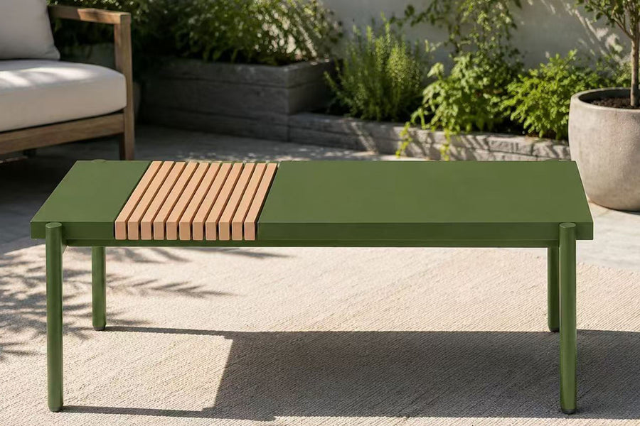 Green outdoor table with wooden slats in a garden setting