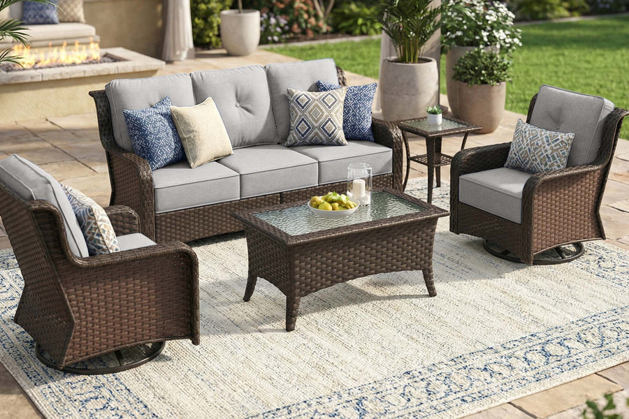 Outdoor patio furniture set with cushions on a patio with a fire pit in the background.