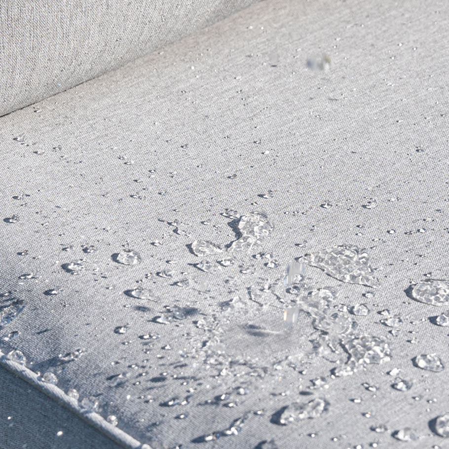 Close-up of a textured gray surface with water droplets.